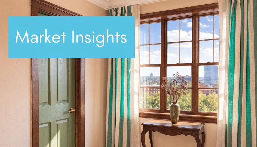 A view through a bright window of a room showcasing the urban landscape of Worcester city