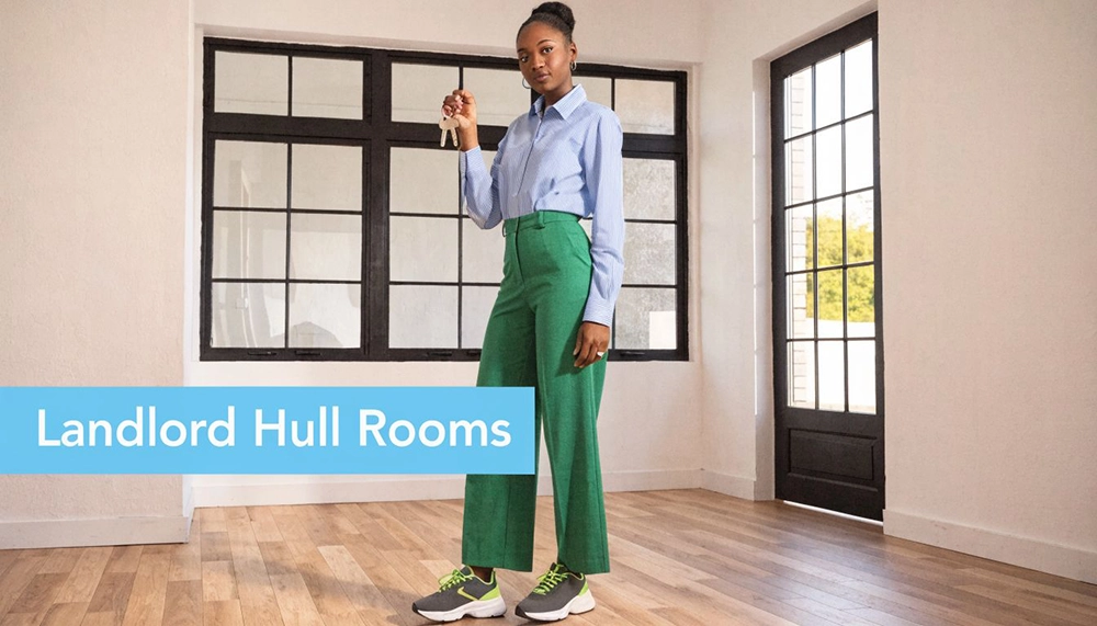A woman stands in a bright, empty room holding up a set of keys, representing property rental services.